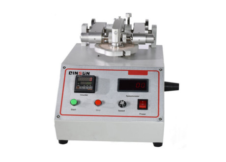 What machine is used to test abrasion resistance?